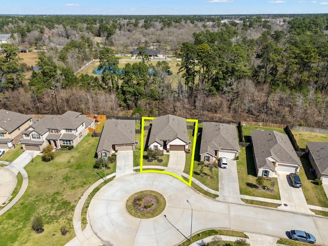 aerial view featuring a residential view and a wooded view