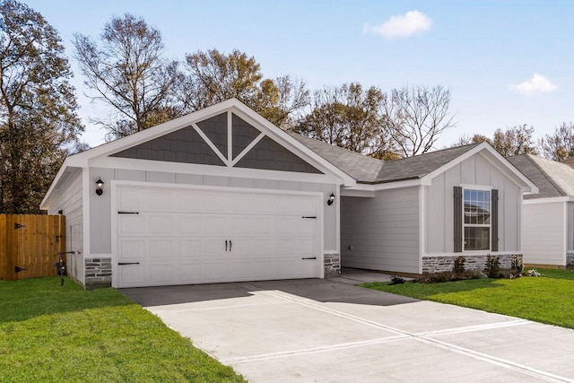 view of front of property with an attached garage, stone siding, a front lawn, and board and batten siding