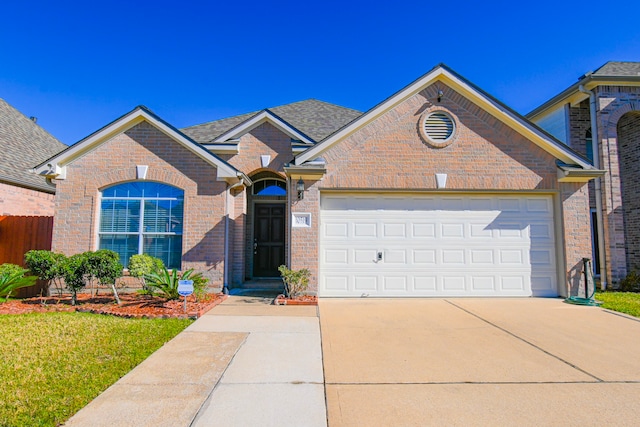 ranch-style house featuring concrete driveway, roof with shingles, an attached garage, fence, and brick siding