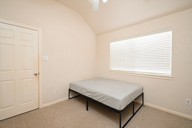 bedroom featuring carpet floors, ceiling fan, baseboards, and vaulted ceiling