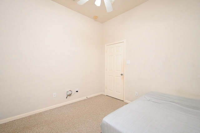 bedroom featuring light carpet, baseboards, and a ceiling fan