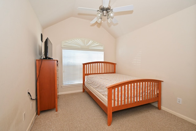 bedroom with light colored carpet, vaulted ceiling, baseboards, and ceiling fan