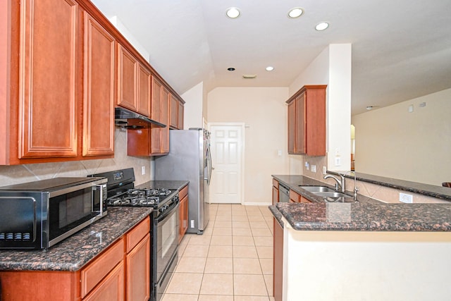 kitchen featuring stainless steel microwave, black gas stove, under cabinet range hood, a sink, and light tile patterned flooring