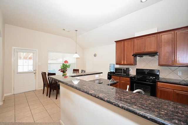 kitchen featuring light tile patterned floors, decorative backsplash, lofted ceiling, black range with gas stovetop, and under cabinet range hood