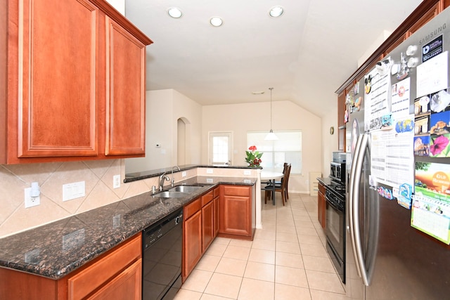 kitchen featuring light tile patterned floors, a peninsula, a sink, vaulted ceiling, and black appliances