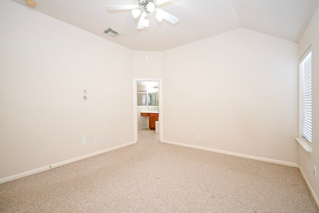 unfurnished room with lofted ceiling, visible vents, plenty of natural light, and light carpet