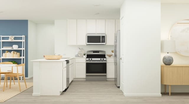 kitchen with appliances with stainless steel finishes, white cabinets, a peninsula, and light wood finished floors