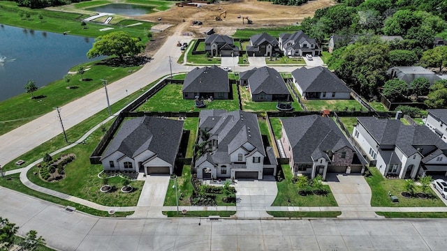 drone / aerial view with a water view and a residential view