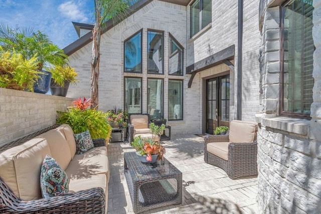 view of patio featuring outdoor lounge area and fence