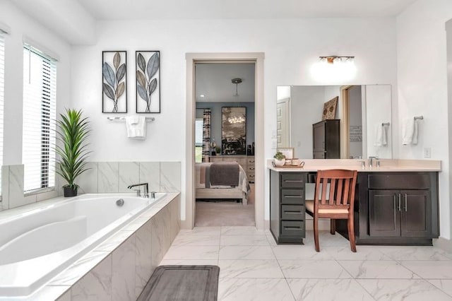 full bath featuring marble finish floor, vanity, connected bathroom, and a bath