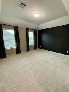 unfurnished room featuring light carpet and visible vents