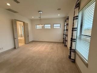 empty room featuring light carpet, visible vents, baseboards, and recessed lighting