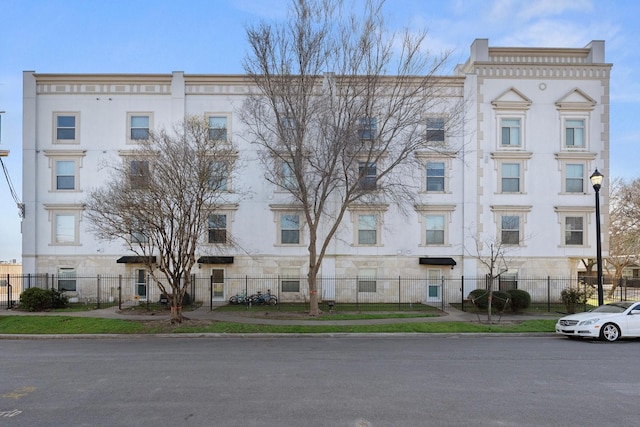 view of building exterior featuring a fenced front yard