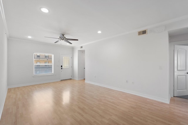 unfurnished room with ornamental molding, visible vents, light wood finished floors, and baseboards