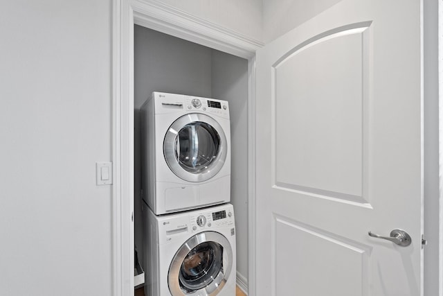 laundry area featuring laundry area and stacked washer and clothes dryer