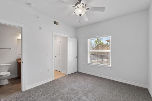 unfurnished bedroom featuring baseboards, visible vents, and carpet flooring