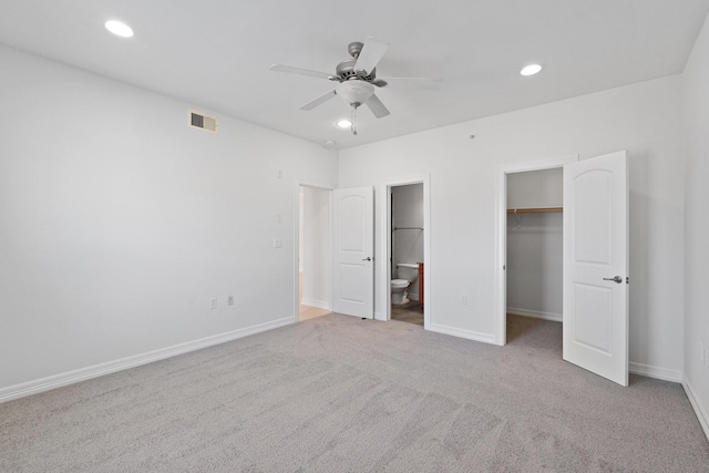 unfurnished bedroom with recessed lighting, visible vents, a spacious closet, and baseboards