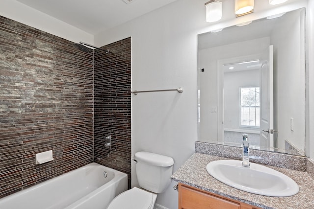 bathroom featuring toilet, shower / bath combination, and vanity