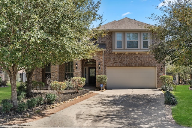 view of front of home with concrete driveway, stone siding, an attached garage, fence, and brick siding