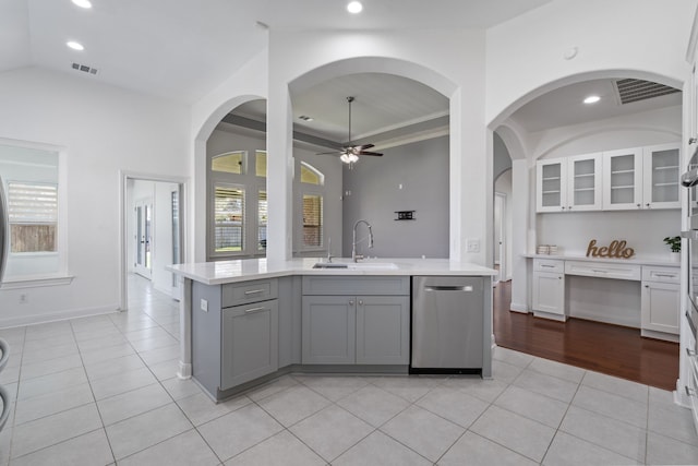 kitchen with a sink, visible vents, dishwasher, and light countertops