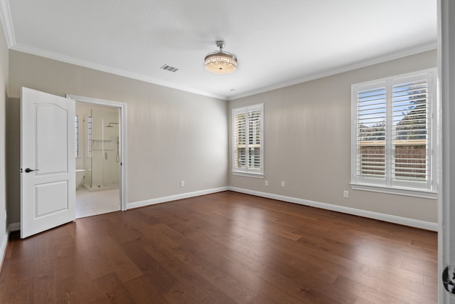 unfurnished bedroom featuring dark wood finished floors, visible vents, crown molding, and baseboards