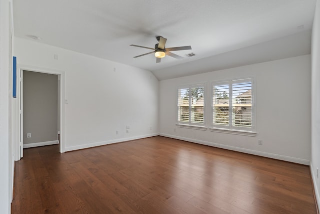 spare room with visible vents, dark wood-type flooring, baseboards, lofted ceiling, and a ceiling fan