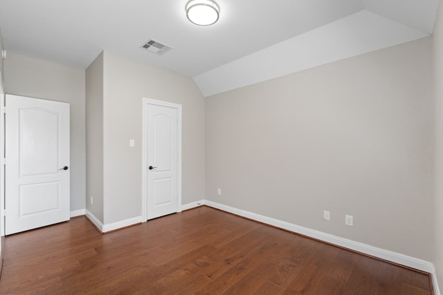 interior space with visible vents, baseboards, wood finished floors, and vaulted ceiling