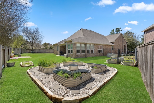 view of yard featuring central air condition unit, a vegetable garden, and a fenced backyard