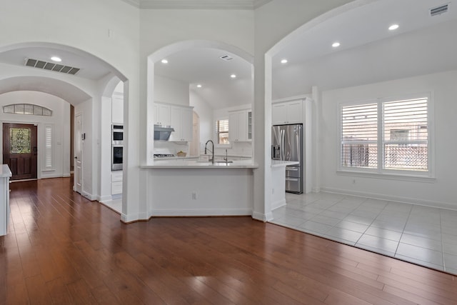 kitchen featuring light countertops, dark wood-style floors, visible vents, and stainless steel appliances