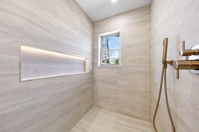 bathroom with a tile shower