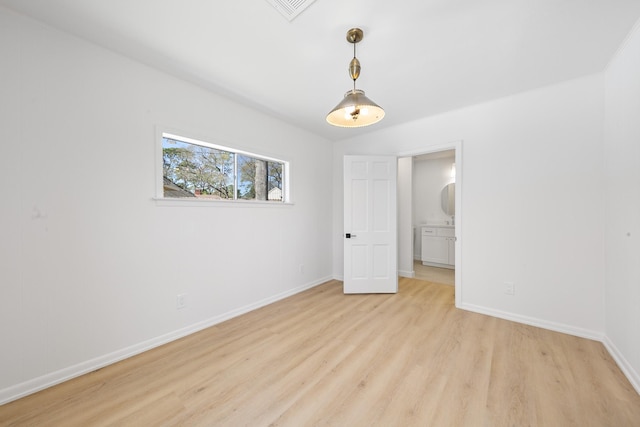 unfurnished bedroom featuring light wood finished floors, visible vents, and baseboards