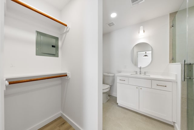 bathroom with visible vents, a shower stall, baseboards, toilet, and electric panel