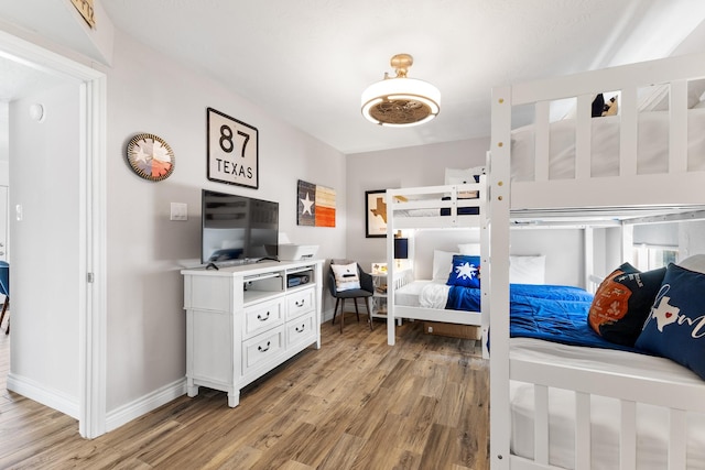 bedroom featuring light wood-style flooring and baseboards