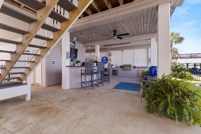 view of patio / terrace with ceiling fan and outdoor dry bar