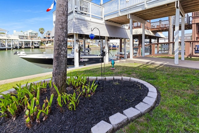 view of community with a water view and a yard