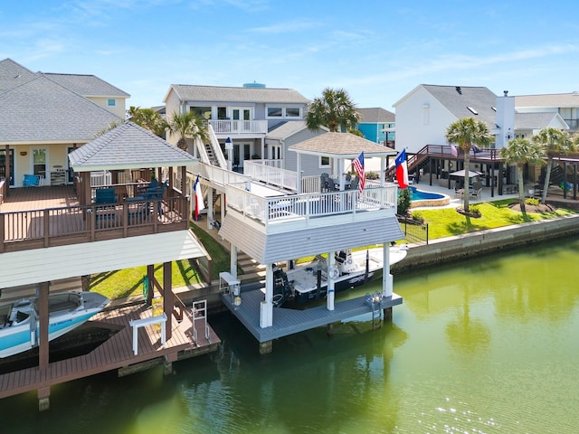 view of dock featuring boat lift, a residential view, a water view, a gazebo, and a yard