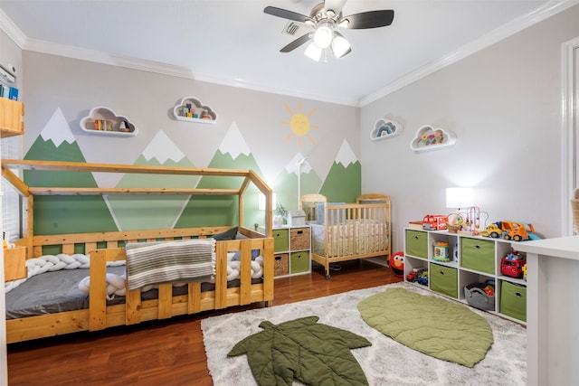 bedroom with crown molding, ceiling fan, and wood finished floors