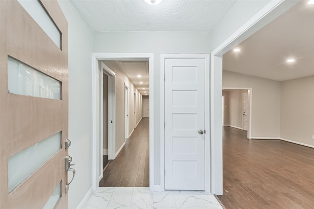 hall featuring attic access, recessed lighting, marble finish floor, and baseboards