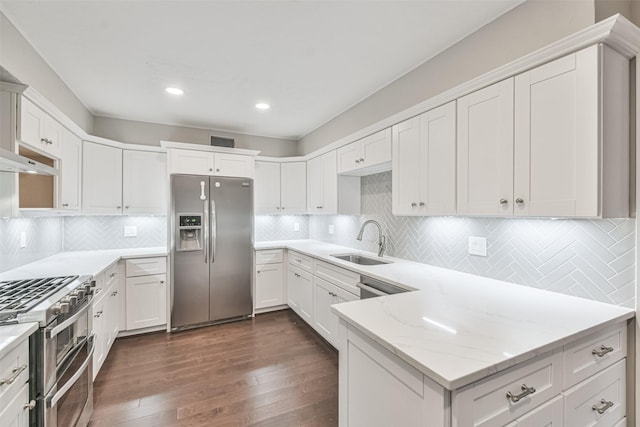 kitchen featuring a sink, visible vents, white cabinetry, appliances with stainless steel finishes, and dark wood finished floors