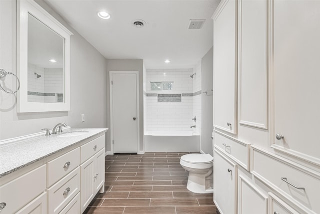 bathroom featuring wood finish floors, visible vents, vanity, and recessed lighting