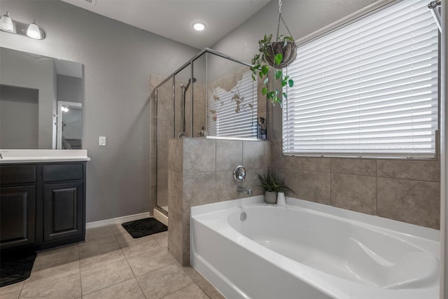 full bathroom with tile patterned flooring, a garden tub, vanity, baseboards, and a stall shower