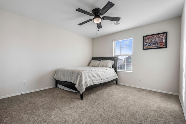 carpeted bedroom with baseboards, visible vents, and a ceiling fan