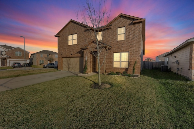 traditional home with driveway, an attached garage, and brick siding