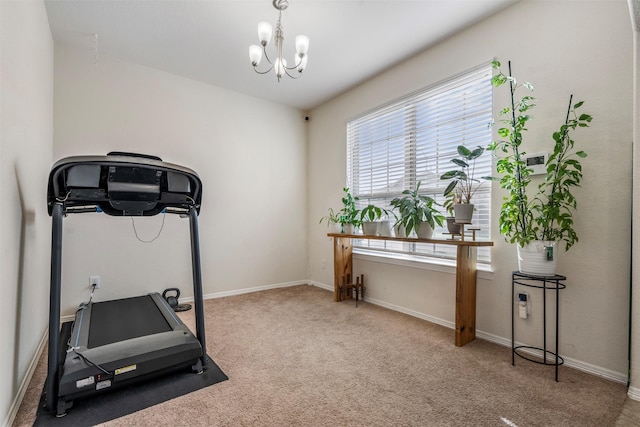 workout room with carpet, a notable chandelier, and baseboards