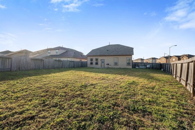 view of yard with a fenced backyard