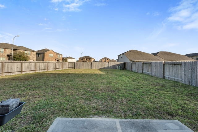 view of yard with a residential view and a fenced backyard