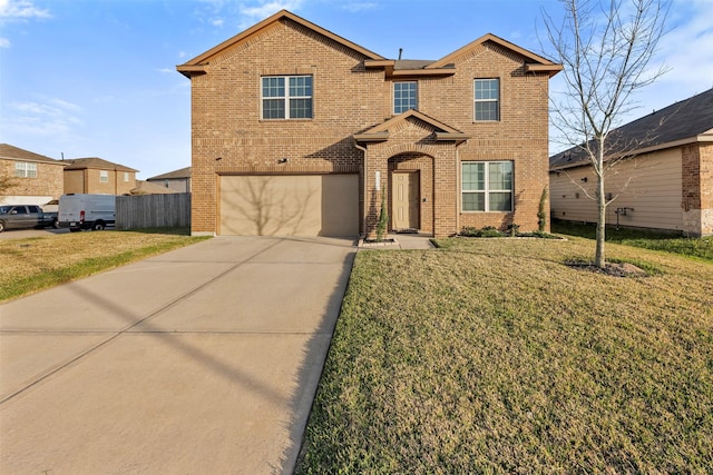 traditional home with an attached garage, driveway, brick siding, and a front yard