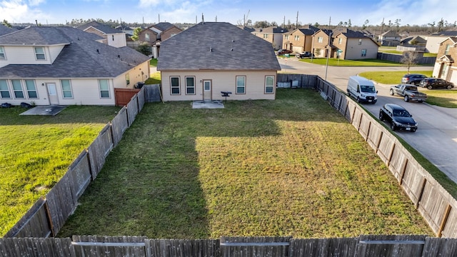 exterior space with a fenced backyard and a residential view