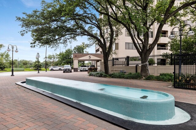 view of pool featuring fence