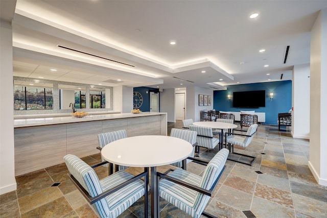 dining area with recessed lighting, baseboards, and stone tile flooring